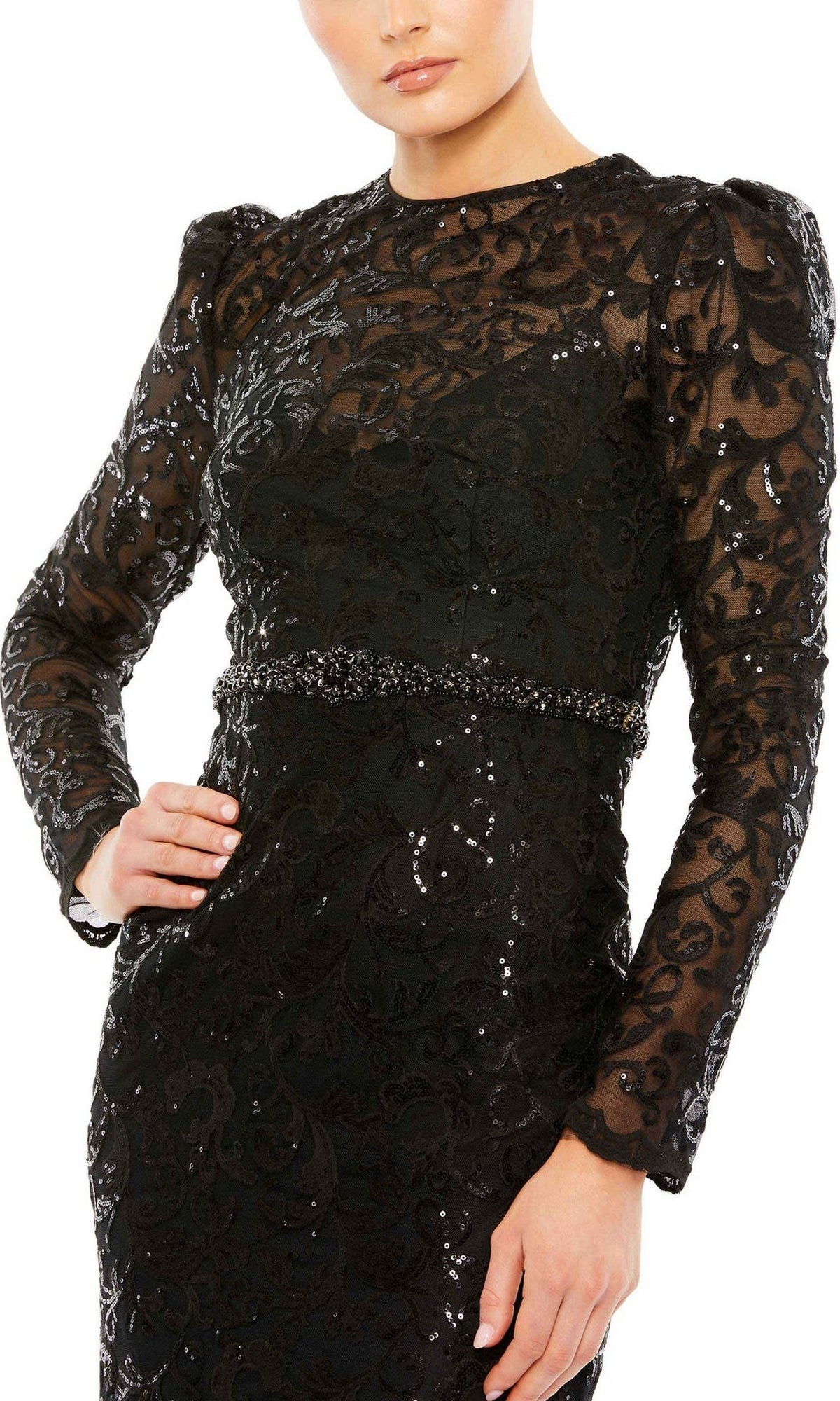 A person wearing the Mac Duggal 68011 Long Beaded-Lace Formal Dress, featuring black long sleeves, a fitted waist, sequin and lace detailing, and sheer accents on the sleeves and chest.
